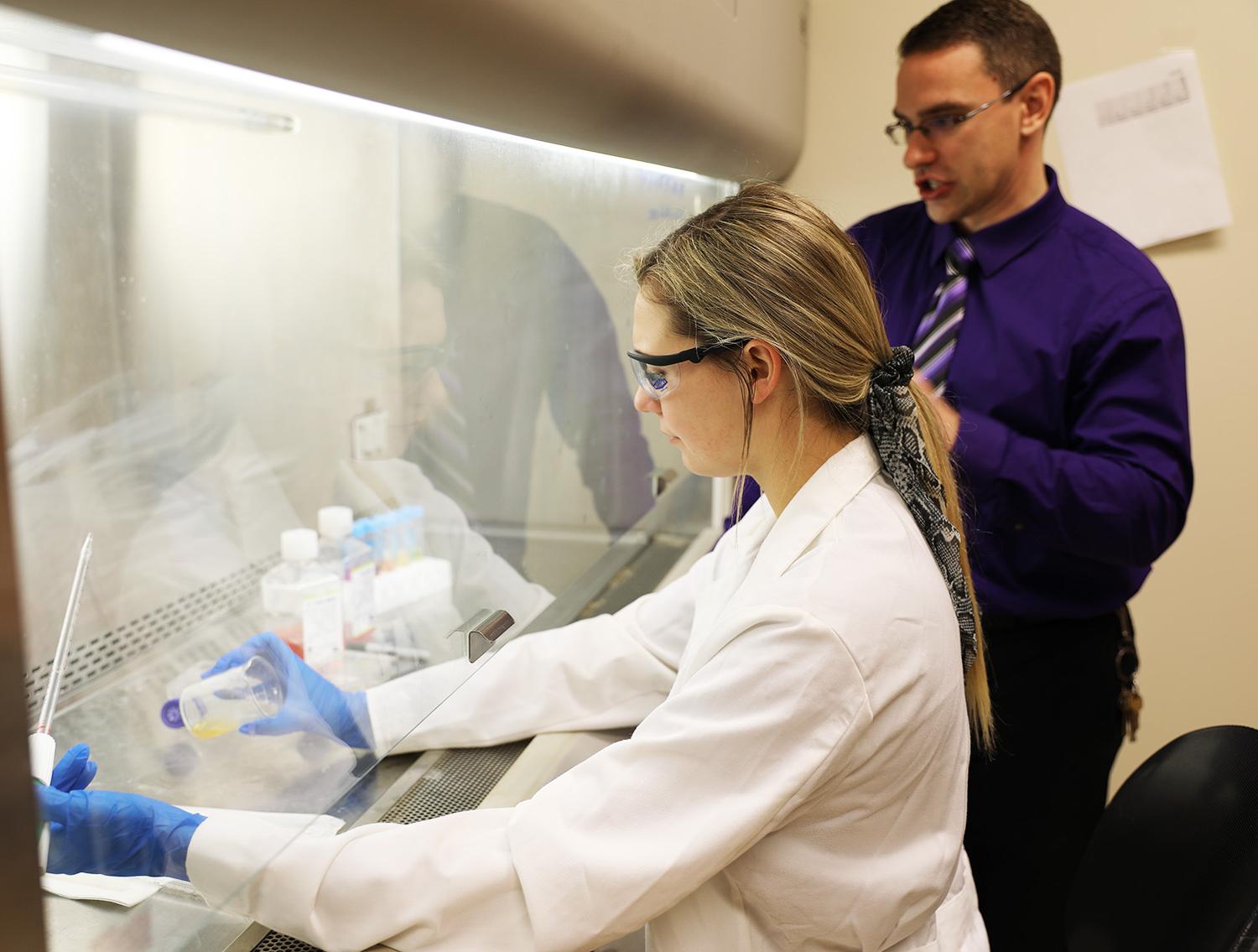 student with professor in lab